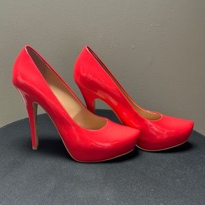 Red/orange 5|48 platform pumps. Heels are 4 inches. These are like-new.